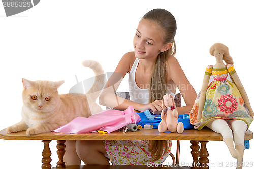 Image of The girl sews toys from fabric