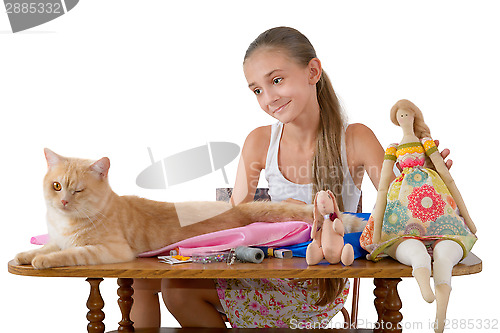 Image of The girl sews toys from fabric