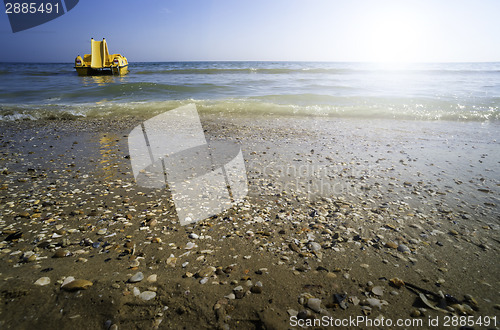 Image of Yellow lifeboat on the beach.