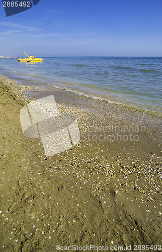 Image of Yellow lifeboat on the beach.
