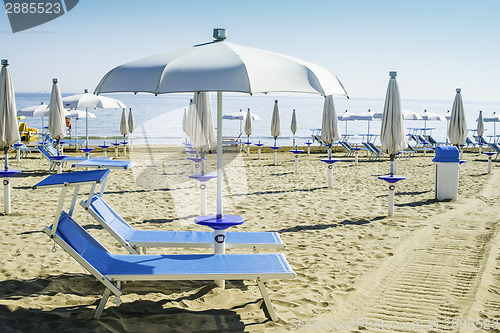 Image of Sunbeds and umbrellas on the beach