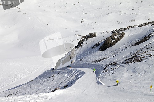 Image of Snowboarders and skiers on groomed slope