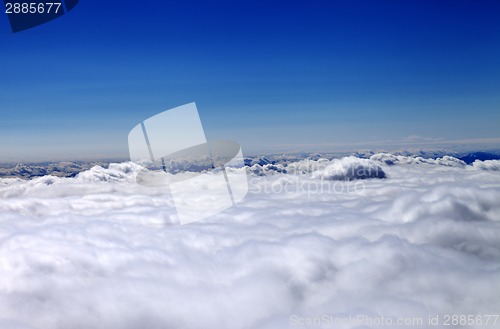 Image of Mountains under clouds in sunny winter day