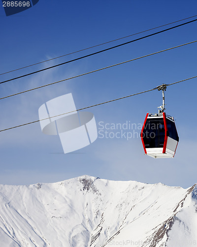 Image of Gondola lift and snowy mountains