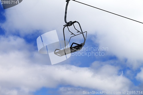 Image of Chair-lift and blue sky with clouds