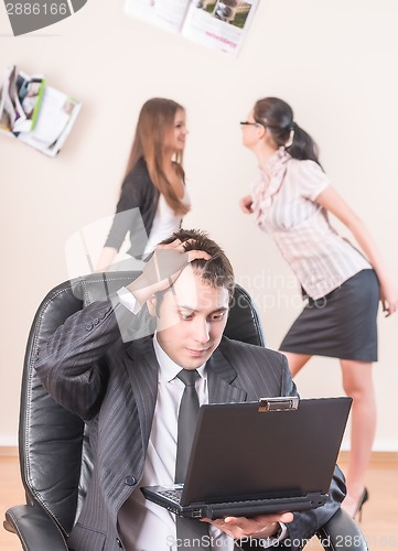 Image of Businessman works with laptop and is distressed