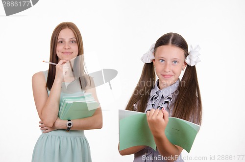 Image of Trainee writes in a notebook, the teacher pleased