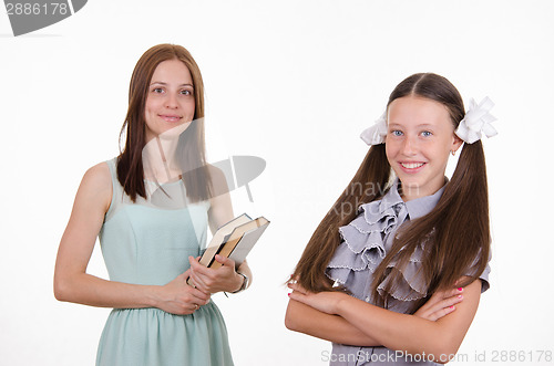 Image of Teacher with books and confident student