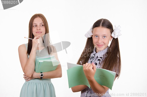 Image of Trainee writes in a notebook, answering homework