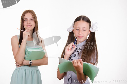 Image of Girl student thought answering the blackboard