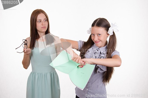 Image of Trainee tears notebook in front of the teacher
