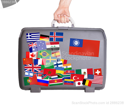 Image of Used plastic suitcase with stickers