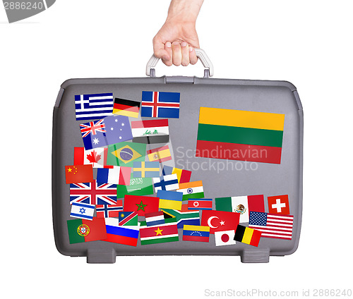 Image of Used plastic suitcase with stickers