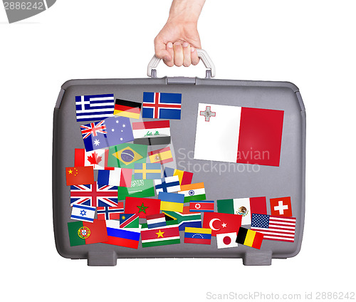 Image of Used plastic suitcase with stickers