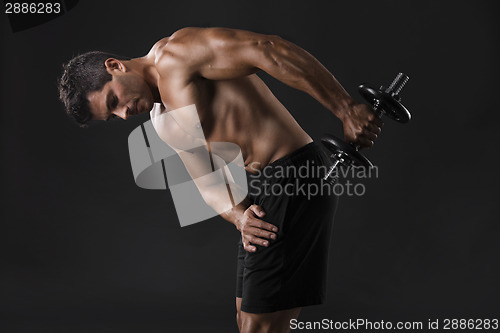 Image of Muscular man lifting weights