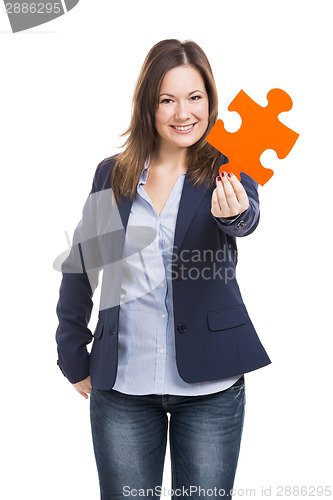 Image of Business woman holding a puzzle piece