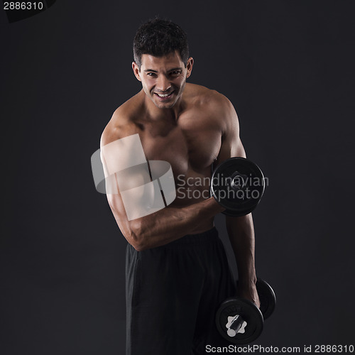 Image of Muscular man lifting weights
