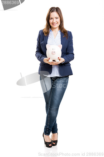 Image of Business woman with a piggy bank