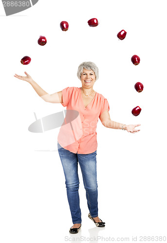 Image of Old woman throwing apples