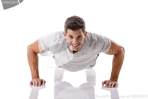 Image of Handsome young man making pushups