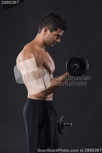 Image of Muscular man lifting weights