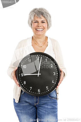 Image of Elderly woman holding a clock