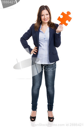 Image of Business woman holding a puzzle piece