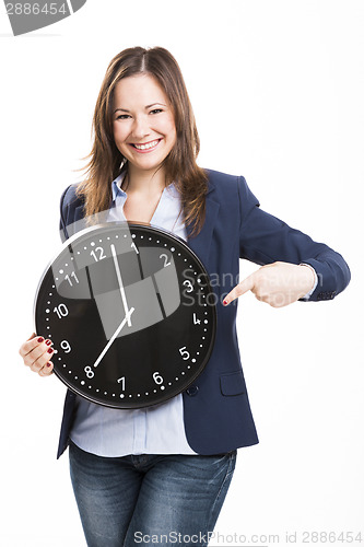 Image of Business woman holding a big clock