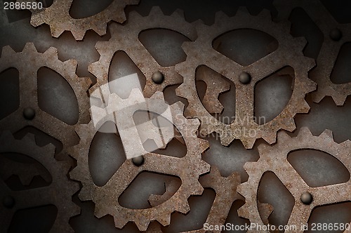 Image of Distressed interlocking gears lit diagonally