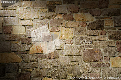 Image of Masonry Wall of Multicolored Stone Lit Diagonally