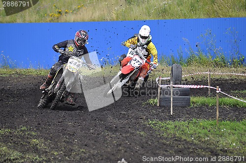 Image of Racers on motorcycles participate in cross-country race competit