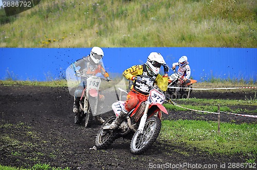 Image of Racers on motorcycles participate in cross-country race competit