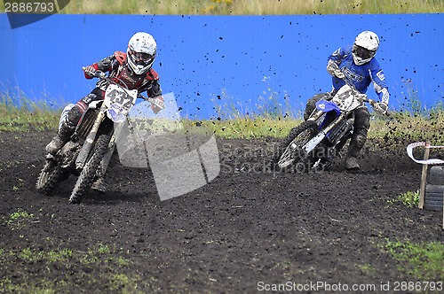 Image of Racers on motorcycles participate in cross-country race competit