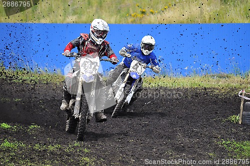 Image of Racers on motorcycles participate in cross-country race competit