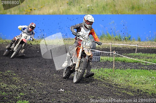 Image of Racers on motorcycles participate in cross-country race competit