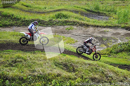 Image of Racers on motorcycles participate in cross-country race competit