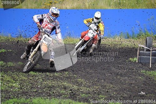 Image of Racers on motorcycles participate in cross-country race competit