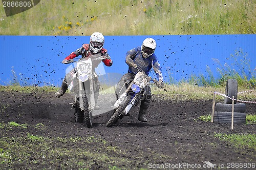 Image of Racers on motorcycles participate in cross-country race competit