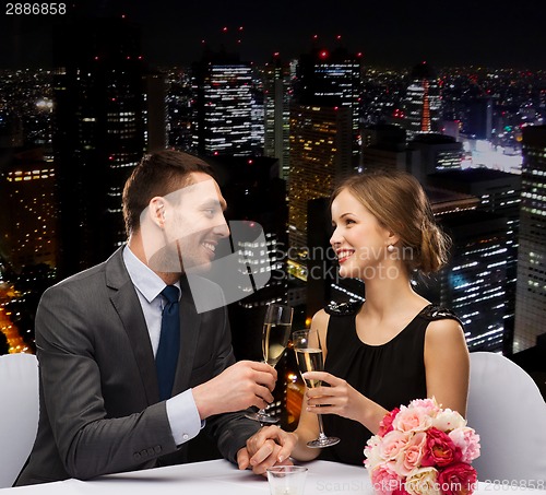 Image of couple with glasses of champagne at restaurant