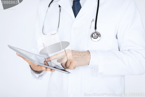 Image of male doctor holding tablet pc
