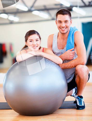 Image of two smiling people with fitness ball