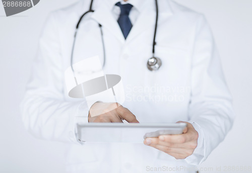 Image of male doctor holding tablet pc