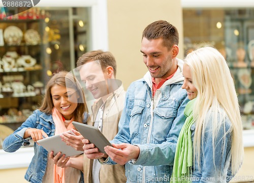 Image of group of smiling friends with tablet pc computers