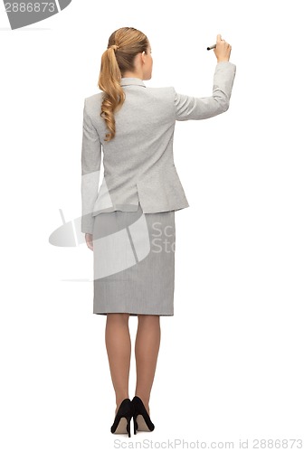 Image of businesswoman or teacher with marker from back