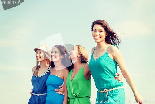 Image of girls walking on the beach