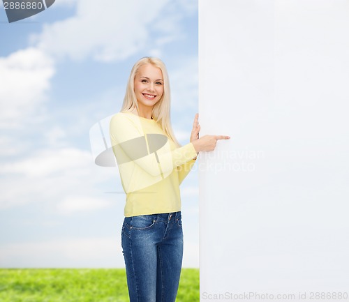 Image of smiling woman in sweater with blank white board