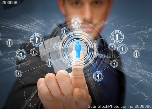 Image of businessman pressing button with contact