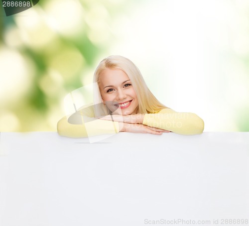 Image of smiling woman in sweater with blank white board