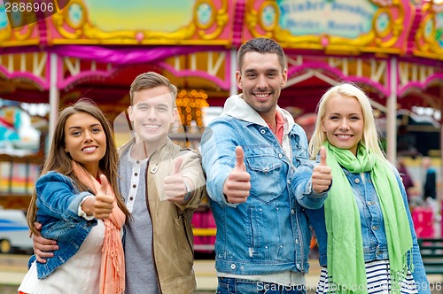 Image of group of smiling friends showing thumbs up