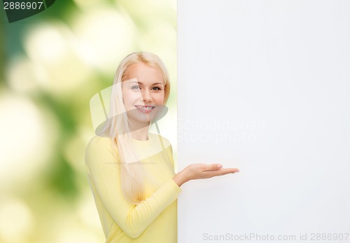 Image of smiling woman in sweater with blank white board